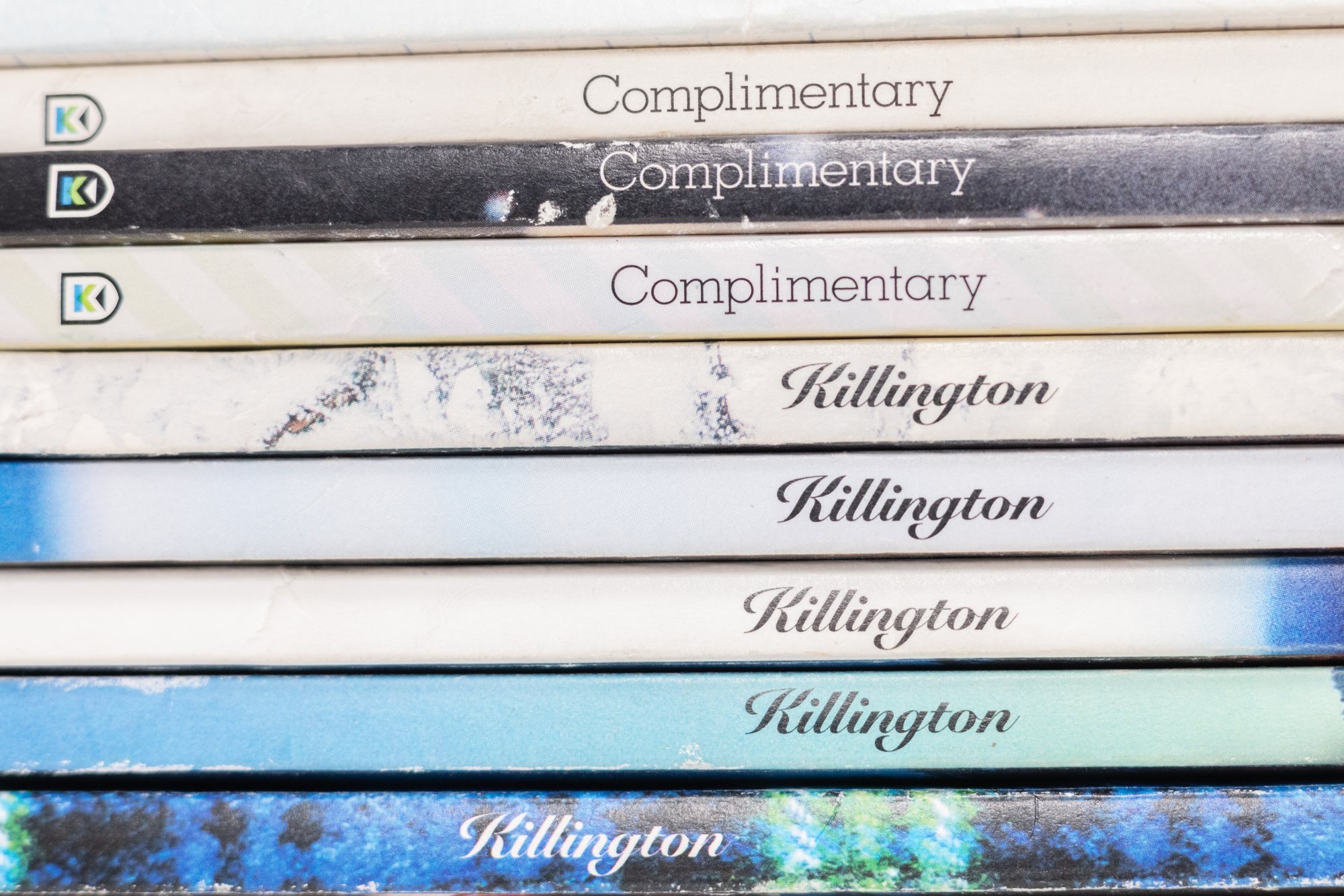 A decade of 4241 and Killington magazines stacked spine-out — 'Complimentary' and 'Killington' issues