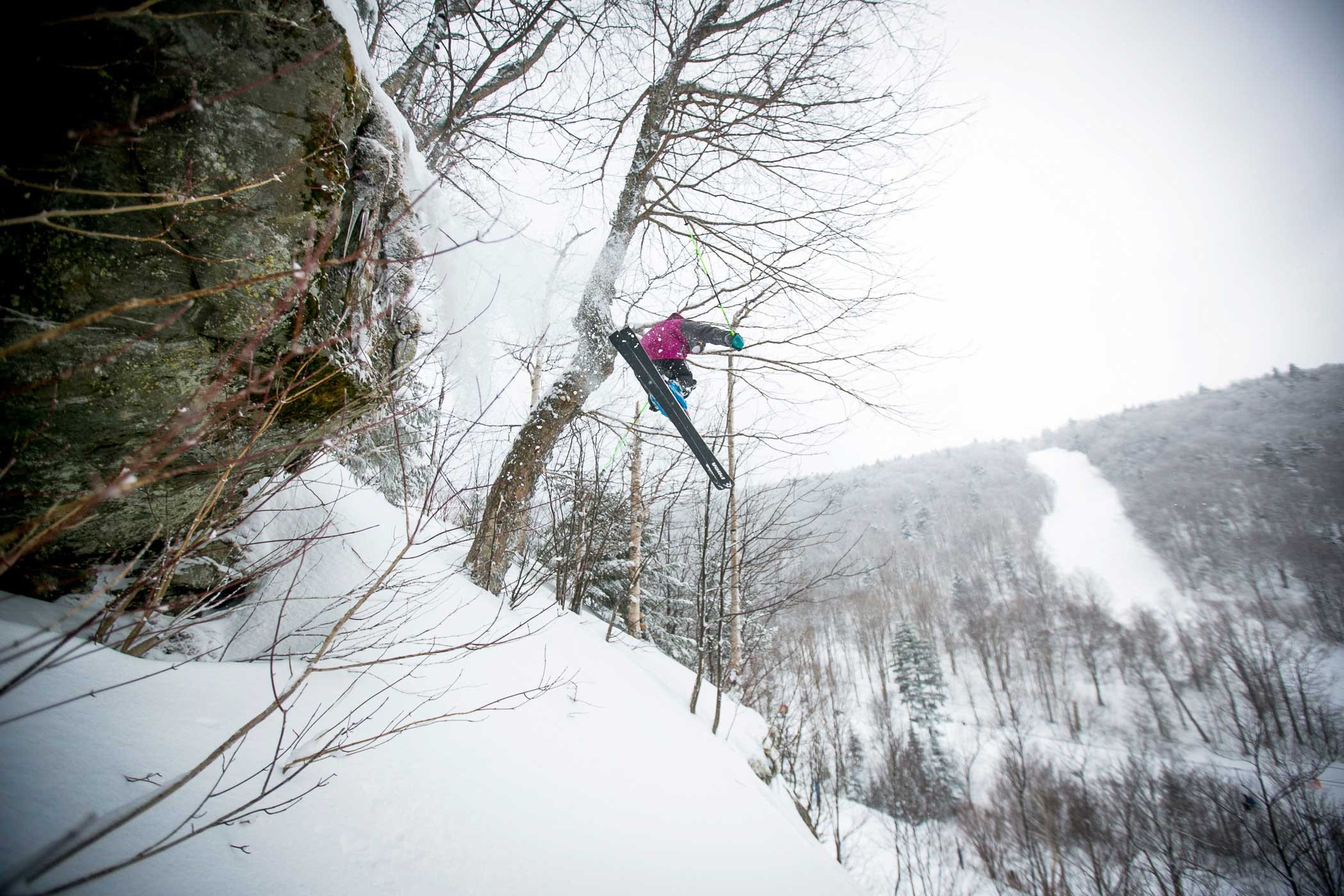 A skier dropping a snow-covered cliff line at Killington — the Beast in its element