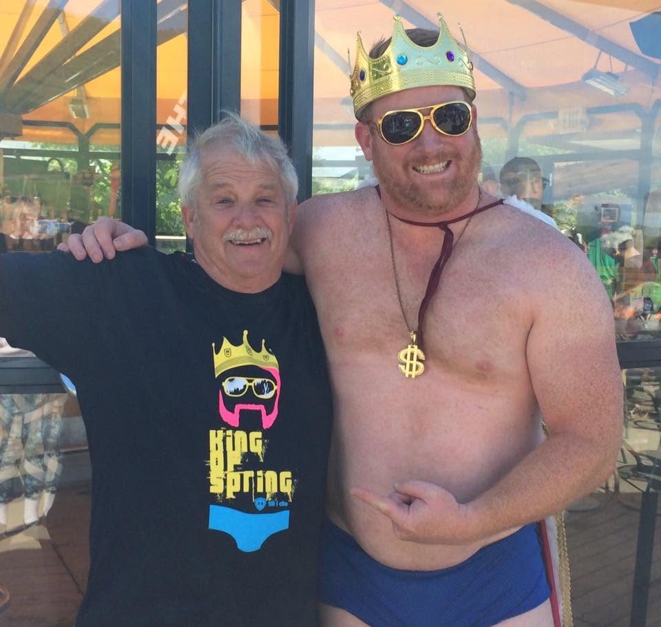 The King and a longtime fan grinning at the umbrella bar