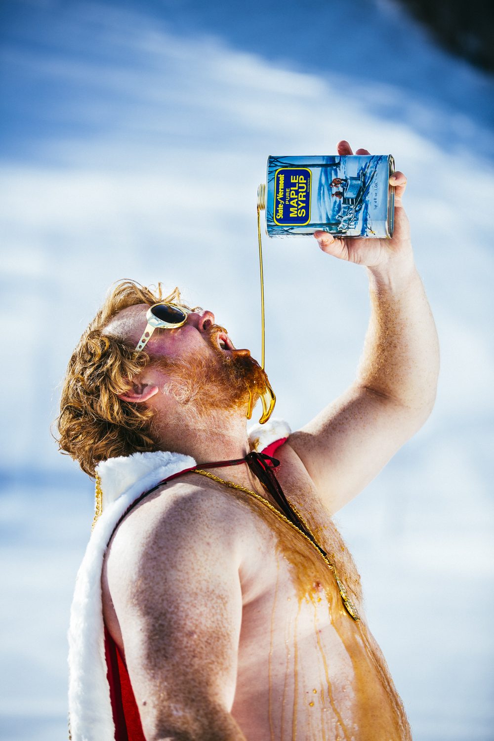The King pouring Vermont maple syrup, crown and cape on